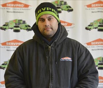 Crew Chief Josh Cunha poses in front of our SERVPRO backdrop